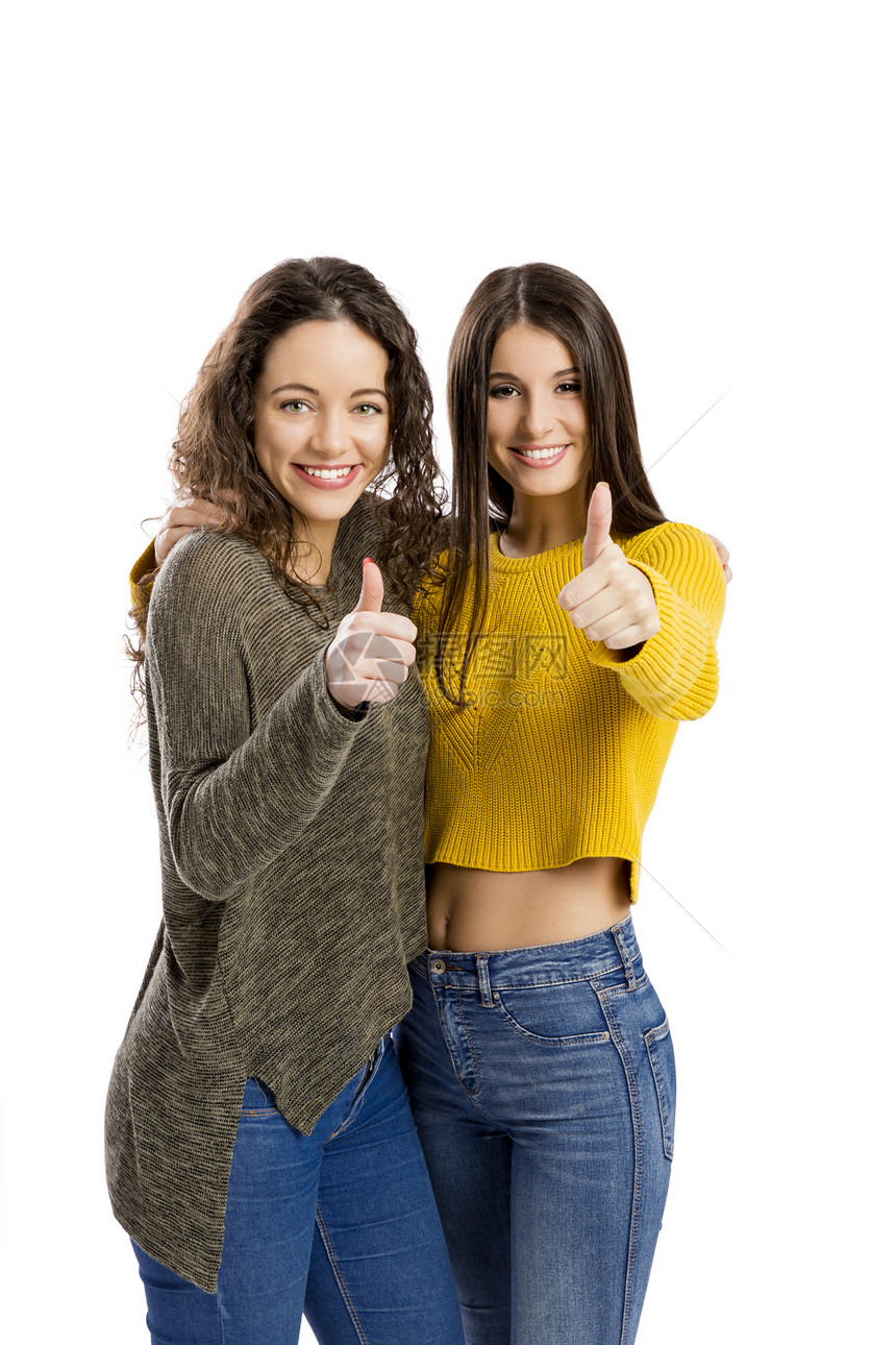 快乐的两个高拇指美女的演播室肖像白色的西班牙裔图片