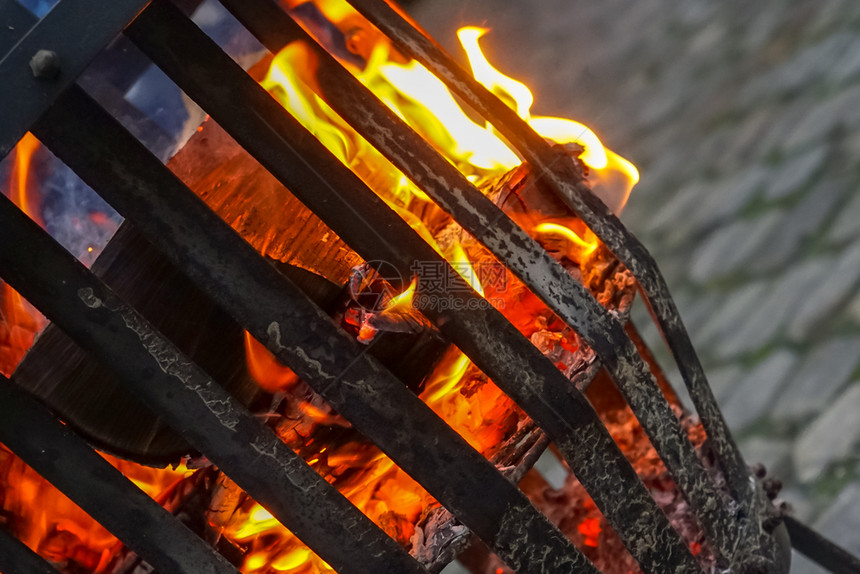 热雪冬季在用灰色铺面石覆盖的地方炉子着火烧自蜂蜜木和橡树的头炉排图片