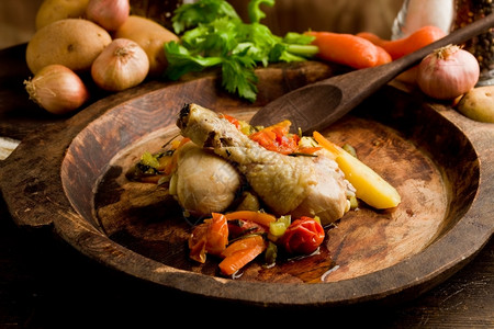 食物美味的炖鸡和蔬菜在生锈木制板内橄榄图片