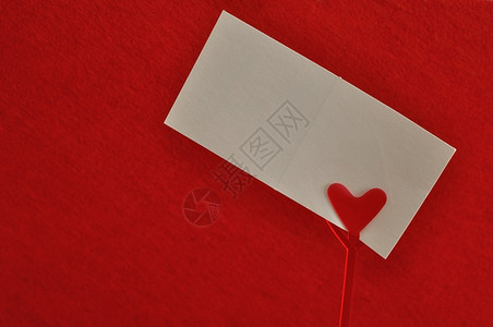 红心纸牌持笔记有人用红色背景的空卡片隔着一张白卡片浪漫持有者空的图片