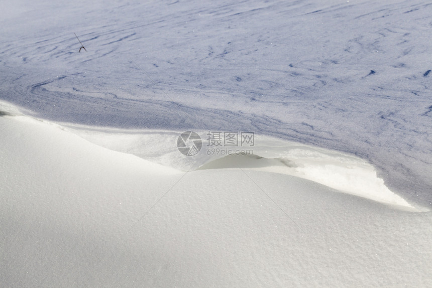 土地下雪的耀斑大漂向阳光关闭美丽的结构在冬天寒冷的雪中飘动体图片