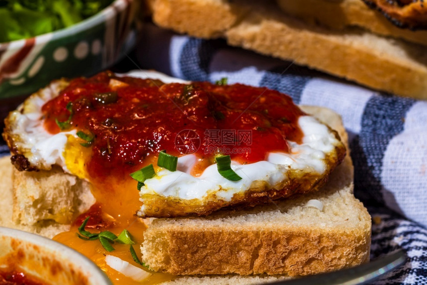 蛋黄用番茄酱和大蒜在烤面包上分离的煎蛋特写白色晴天图片