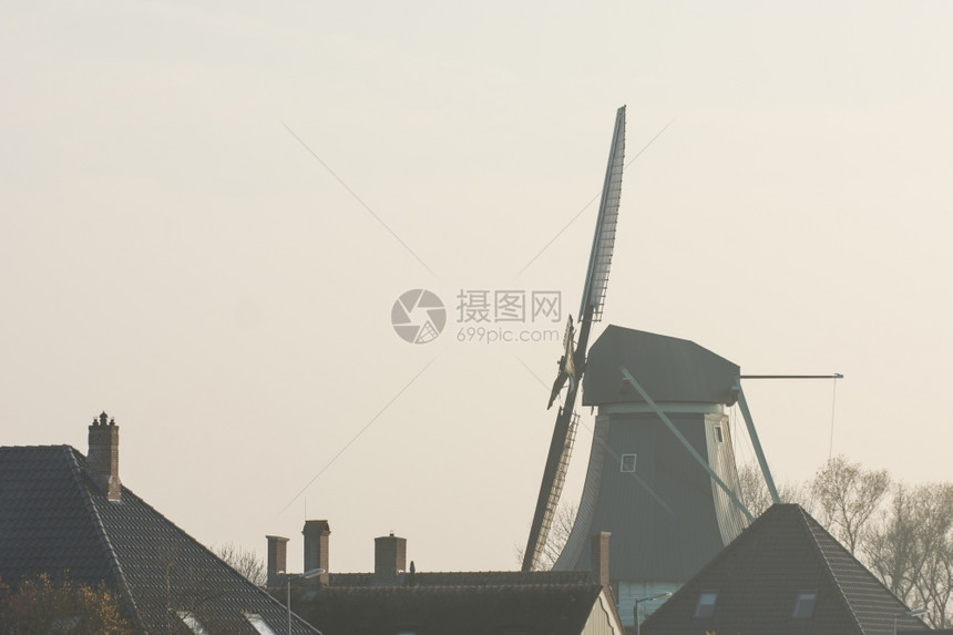 日落与古老的荷兰风车纪念碑田园诗般的冬天图片