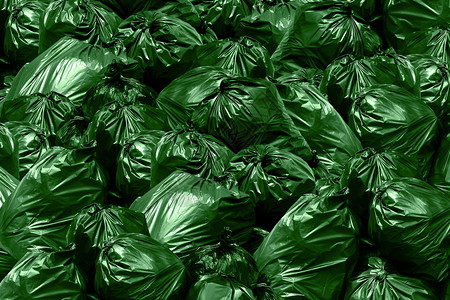 斌满的倾倒背景垃圾场绿色袋箱塑料袋堆图片
