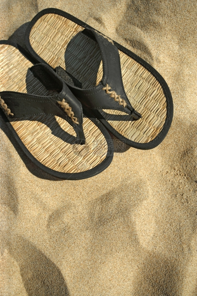在热带海滩的沙上躺着凉鞋图像翻动放松假期图片