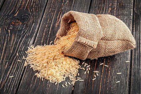 粗麻布一大堆米都埋在木制背景上一片大米的谎言农业美食图片