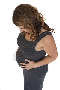 肚脐投标成年孕妇将手握在肚子上向下看等待图片