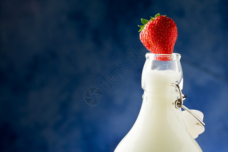 起司液体瓶子牛奶的相片上面有新鲜红草莓图片