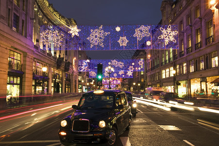 夜晚庆典圣诞节的摄政街和出租车计程英国的图片