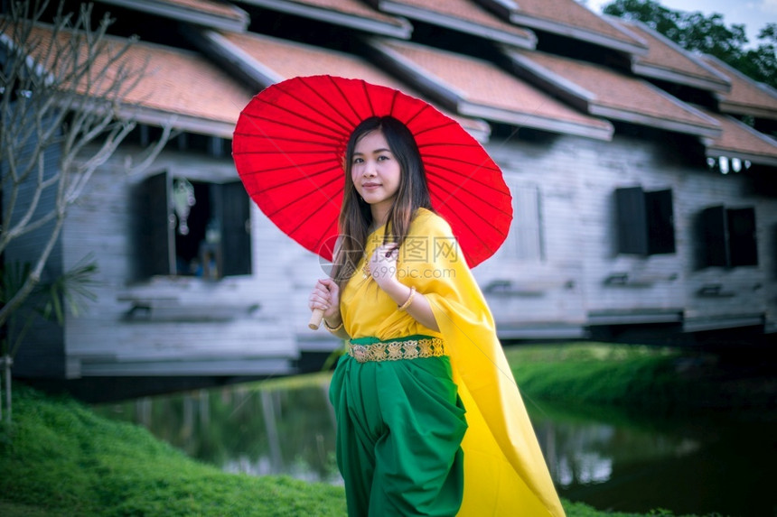 戏服吸引人的漂亮泰国妇女以伞式传统风格装饰泰国妇女图片