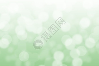 绿色和白bokeh背景的简要光环闪发散焦假期图片