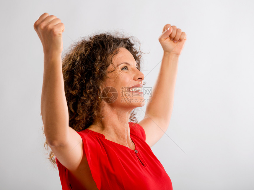 一个快乐的中年黑发女人肖像手举起来表示胜利美丽的情感轮廓图片