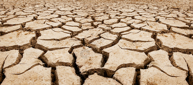 泥土地棕色的裂缝遭受干旱土地大面积区的一部分裂口巨大的设计图片