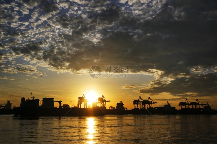 码头贮存商业装集箱货物和起重机桥的港口仓库轮光图片