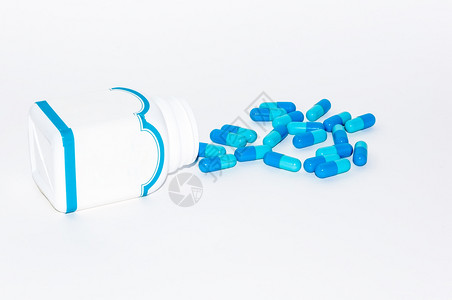 医疗的关心科学白色背景的药瓶中蓝胶囊Blue药物胶囊图片