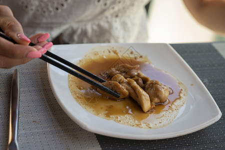 煮熟的健康女人在餐厅吃亚洲菜鸡肉加和铁谷辣酱汤匙加勺子一顿饭图片