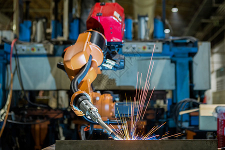 火花液压橙色工业机器人在厂中焊接装配车服务图片