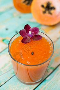 喝木制绿板上的新鲜健康木瓜汁夏天营养丰富高清图片