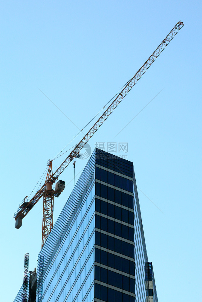 Crane和高楼现代建筑正在造中市心垂直的天空图片