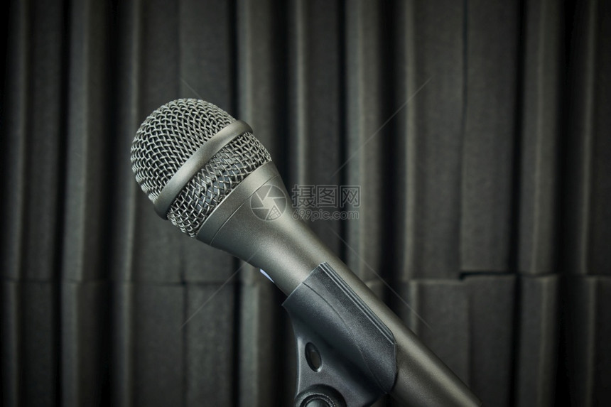 声音专业的娱乐用灰色调装在麦克风台和声波泡沫背景上的侧面麦克风图片