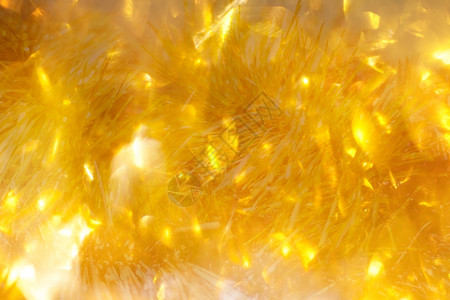 柔和的金色圣诞灯节日散景背抽象的金色背景灰尘发光图片