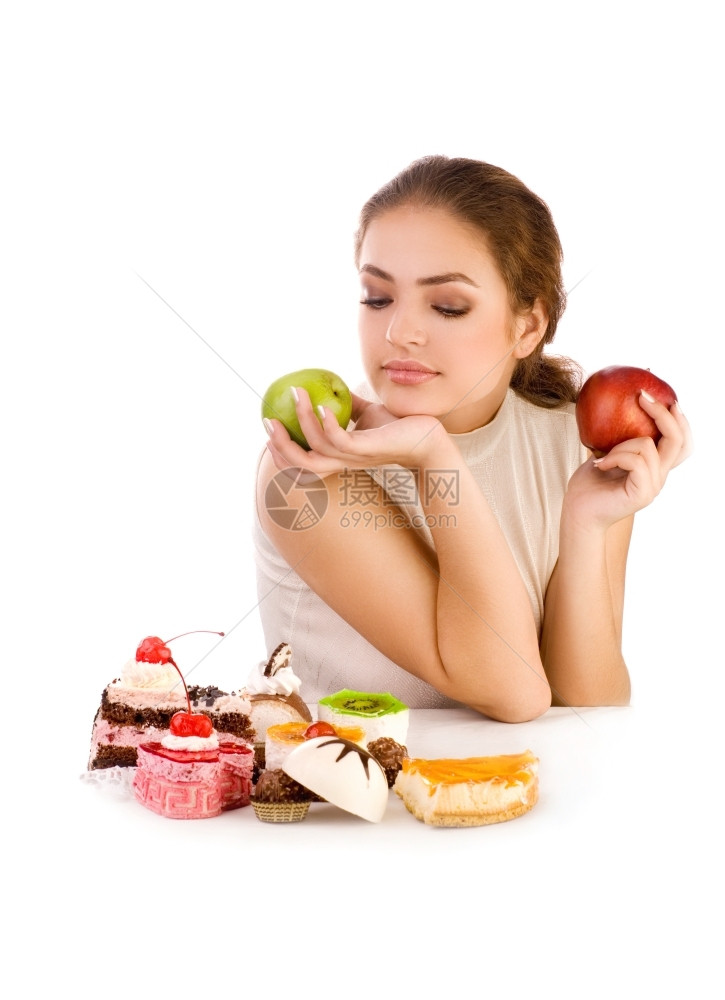摄影有苹果的年轻美女看着曲奇饼白种背景东建造图片