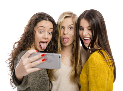 友谊青少年拥有智能手机的少女自拍年轻图片