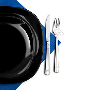 环境蓝色餐巾纸上的黑板叉和刀优雅图片