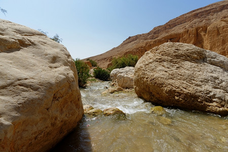 泡沫约旦沙漠中的WadibinHammad小溪流巨石图片