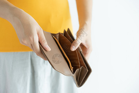 女手打开空的棕色皮钱包没有在白色背景的口袋里危机交易贫困图片