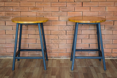房间砖墙背景的两张木制椅子内部的座位图片