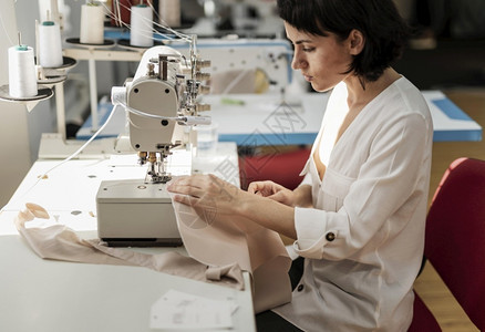 工作场所从事缝纫机工作的妇女准确复古的图片