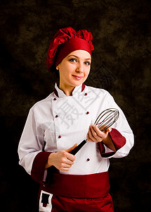 白种人年轻成功女厨师手上抽鞭子的相片玻璃自信图片
