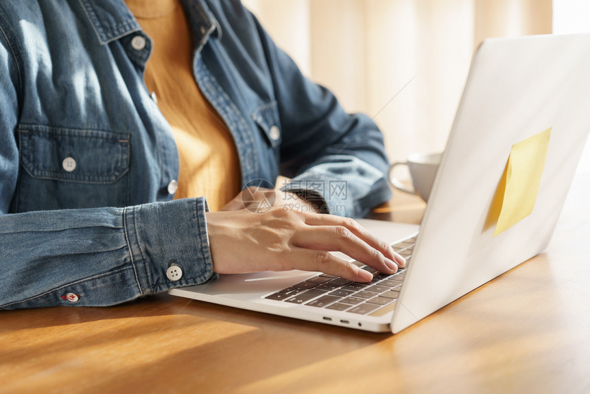 近身手的女工作妇在温暖的清晨阳光下使用笔记本电脑键盘教育早晨沟通图片