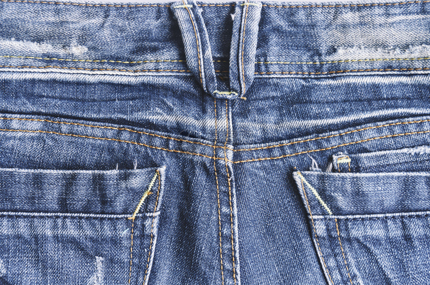 裤子古代蓝色牛仔裤纹身的背面和口袋合上织物撕裂图片