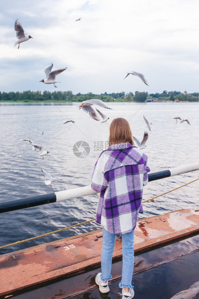 穿越小女孩的后视镜喂海鸥在Cute河上喂养海鸥小可爱的姑娘喂养海鸥白种人成图片