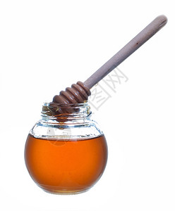 花蜜米尔在白色背景上被隔离的带木制干洗机的蜂蜜罐甜味剂背景图片