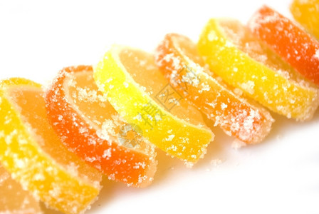 吃水果冻柑橘糖橙色和柠檬隔离在白色多汁的图片