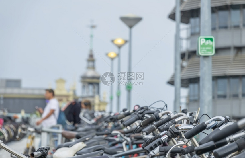 街道户外荷兰阿姆斯特丹温暖的一天阿姆斯特丹中央车站附近的大型自行车停场阿姆斯特丹中央车站附近的大型自行车停场轮图片