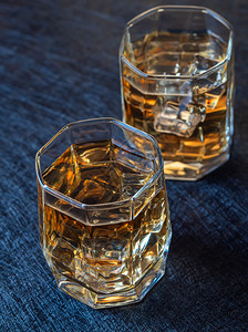 深色背景中加冰的威士忌酒杯两加冰的威士忌空白玻璃岩石图片