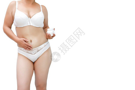 身穿白内裤超重妇女对腹部和大腿施奶油拉紧减肥女图片
