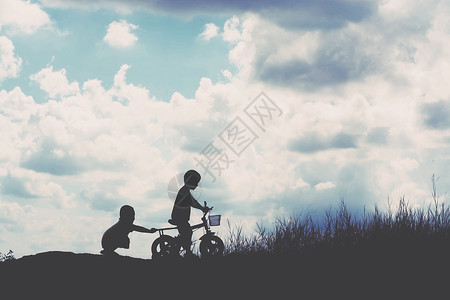 2个小男孩骑自行车的的剪影图片
