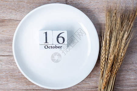 数字健康10月6日历上木制板空白盘子和桌底小麦食物捐赠分享志愿人员和世界粮食日概念慈善机构背景图片