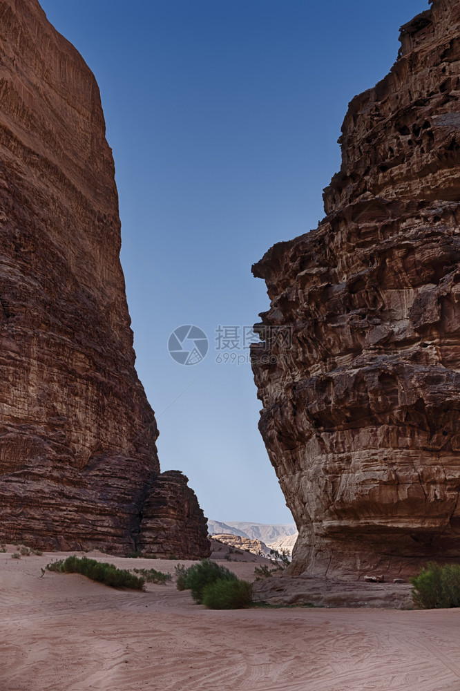 朗姆酒风景优美在约旦南部瓦迪鲁姆沙漠两面悬崖墙之间一片深蓝色的天空分割了一条狭窄的峡谷红色图片