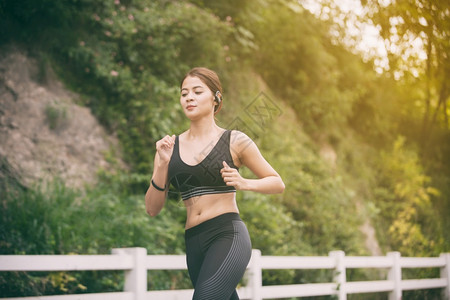 跑步的女人者在户外路上慢跑年轻的混血女孩慢跑竞技耐力夏天图片