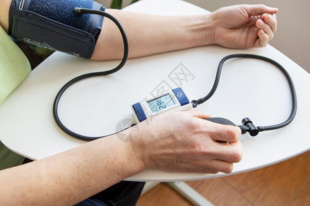 使用血压计测量血压的病人图片