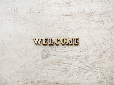 welcome白板顶视图WELCOME棋盘上字母的以WELCOME为形式的字母木制桌子海报背景