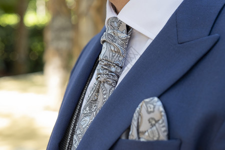 自信的蓝色新郎西装带灰色旧领翻手帕图片