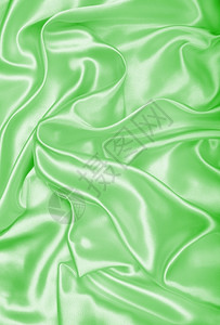 丝滑平优雅的绿色丝绸或纹质可用作背景海浪涟漪图片