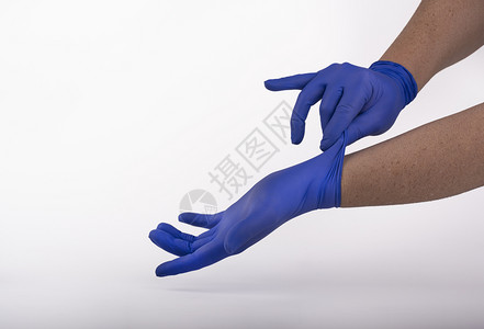 戴蓝色乳胶手套的人图片